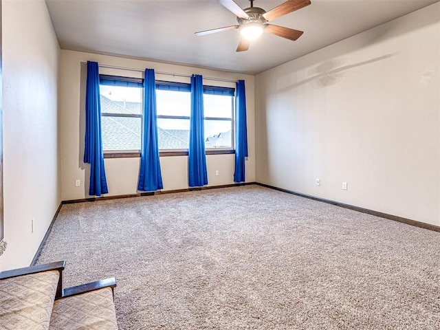 spare room with ceiling fan, baseboards, and carpet flooring