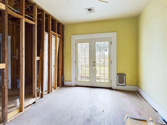 interior space featuring visible vents, wood finished floors, and french doors