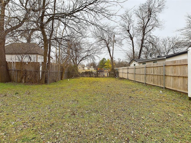 view of yard with a fenced backyard