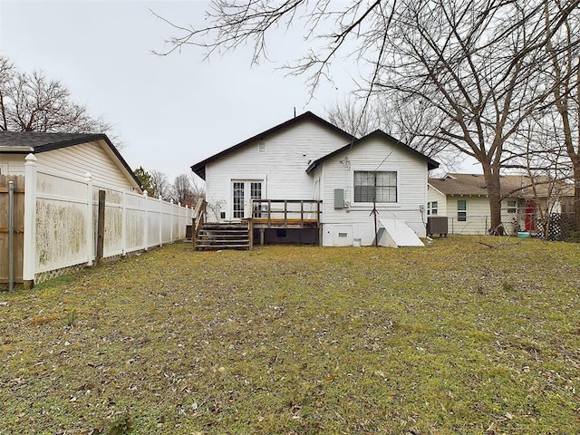 back of property with a lawn, crawl space, central AC, fence, and a deck