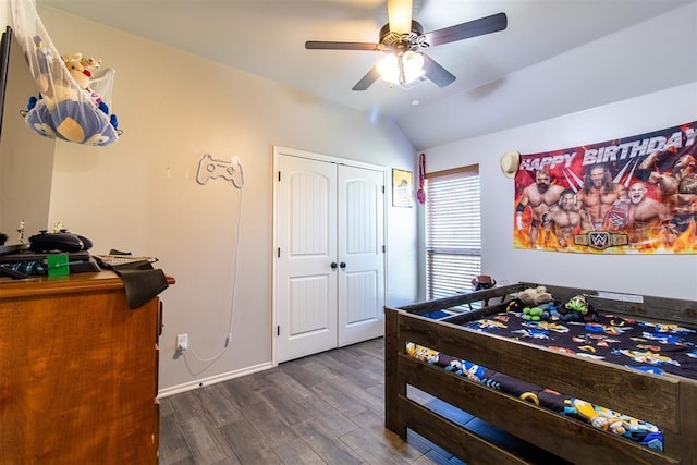 bedroom with lofted ceiling, ceiling fan, dark wood-type flooring, baseboards, and a closet