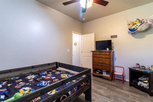 bedroom with ceiling fan and wood finished floors