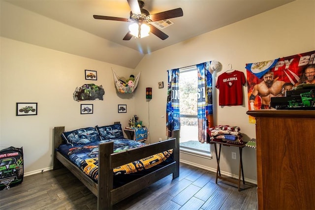 bedroom featuring vaulted ceiling, wood finished floors, visible vents, and baseboards