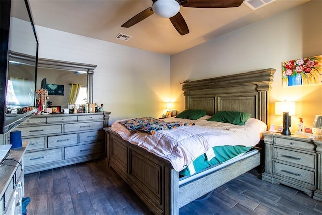 bedroom featuring ceiling fan, visible vents, and dark wood-style flooring