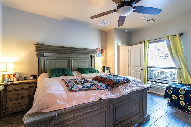 bedroom featuring ceiling fan, wood finished floors, and visible vents