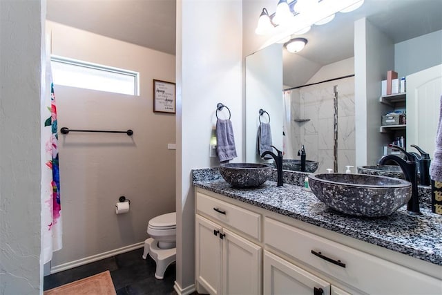 bathroom with toilet, double vanity, a sink, and a shower with shower curtain