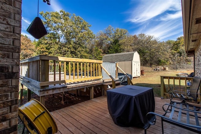 deck with an outdoor structure, grilling area, and a shed