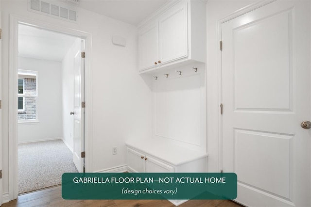 mudroom featuring carpet floors, visible vents, baseboards, and wood finished floors