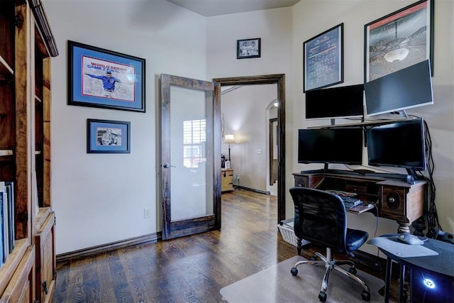 office area with baseboards and wood finished floors