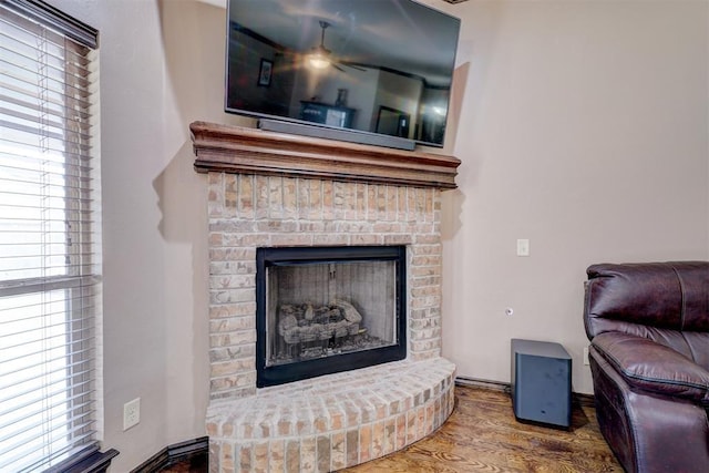 room details featuring a brick fireplace and wood finished floors