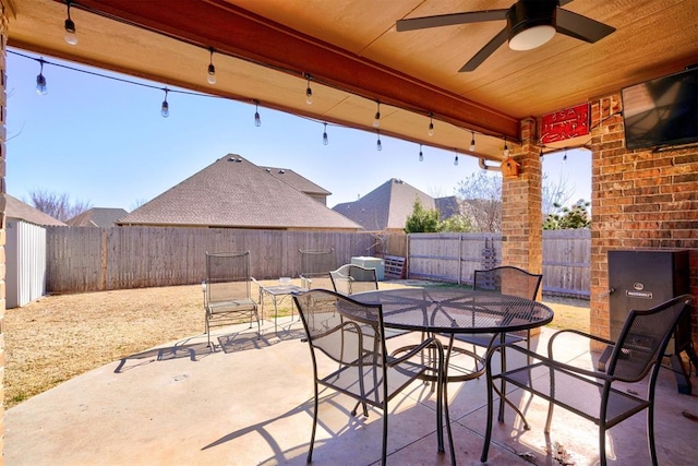 view of patio / terrace featuring ceiling fan, outdoor dining space, and a fenced backyard