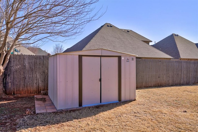 view of shed with a fenced backyard