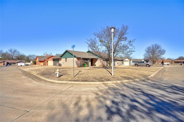 single story home with a garage and a residential view