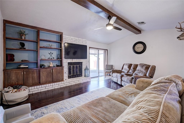 living room with vaulted ceiling with beams, a fireplace, visible vents, a ceiling fan, and wood finished floors