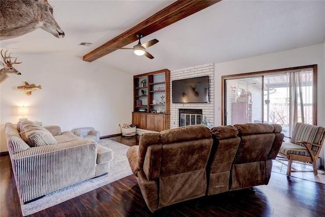 living area with lofted ceiling with beams, a fireplace, wood finished floors, visible vents, and baseboards