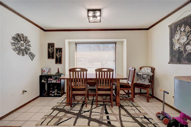 dining room featuring light tile patterned floors, a textured ceiling, baseboards, and crown molding