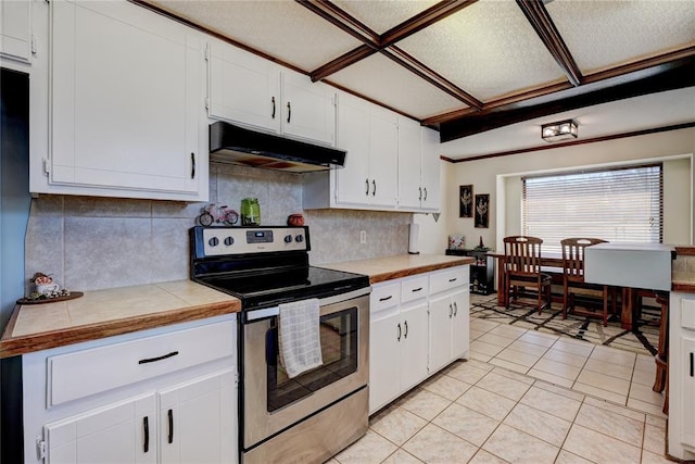 kitchen featuring light tile patterned floors, under cabinet range hood, stainless steel electric stove, white cabinetry, and decorative backsplash