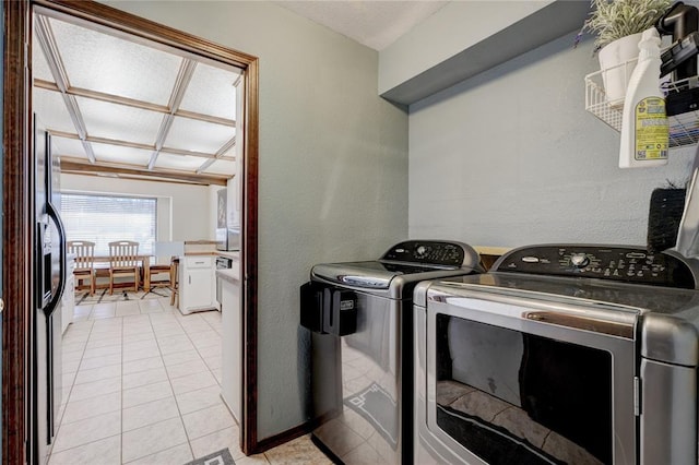 laundry room with light tile patterned floors, laundry area, and washer and clothes dryer