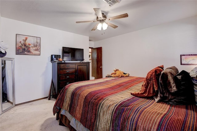 bedroom featuring a ceiling fan, visible vents, light carpet, and baseboards