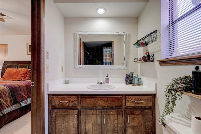 ensuite bathroom featuring ensuite bath and vanity