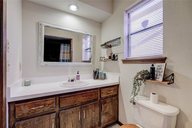 bathroom with toilet and vanity