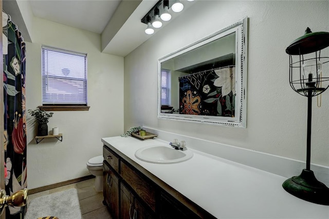 full bath featuring toilet, tile patterned flooring, baseboards, and vanity