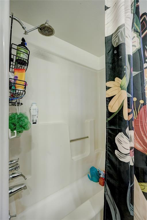 bathroom with shower / bath combo with shower curtain