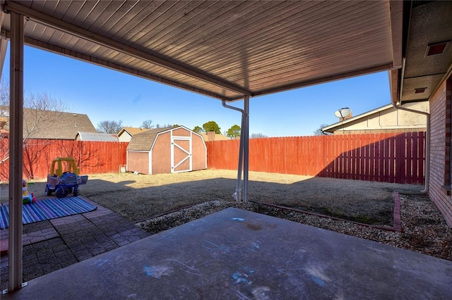 view of patio / terrace with a storage shed, a fenced backyard, and an outdoor structure