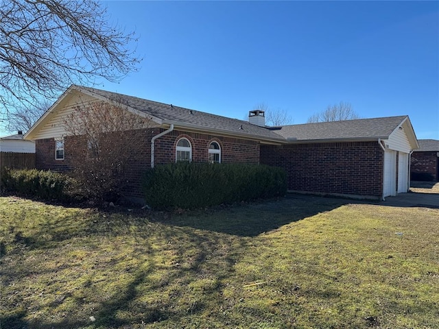 single story home featuring a front lawn, an attached garage, brick siding, and a chimney