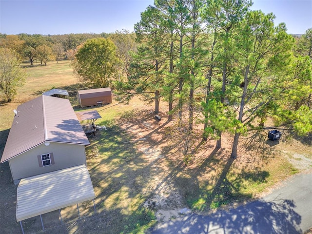 birds eye view of property with a wooded view