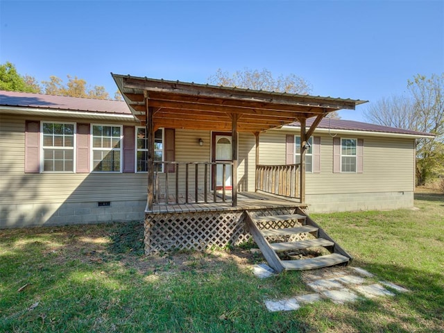 exterior space with a front yard, crawl space, covered porch, and metal roof