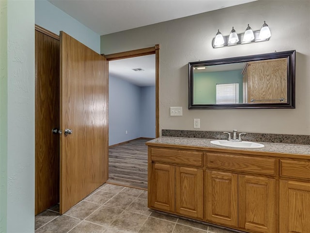 bathroom featuring visible vents, vanity, and tile patterned floors