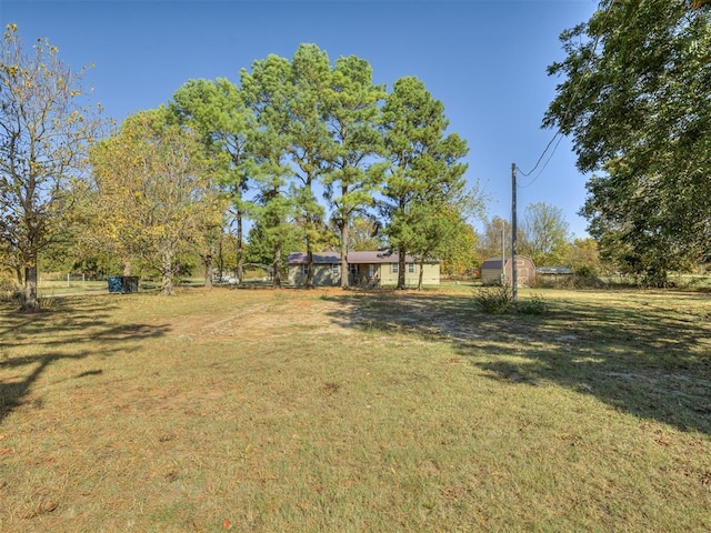 view of yard featuring a storage shed and an outbuilding