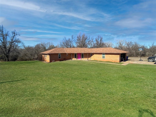 exterior space with a front yard, an attached garage, and driveway