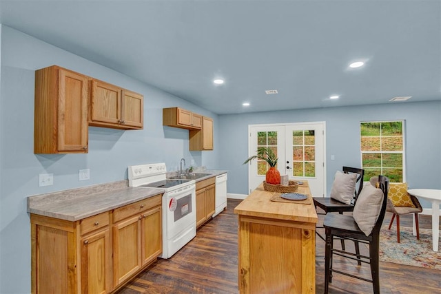 kitchen featuring recessed lighting, white appliances, a sink, french doors, and dark wood-style floors