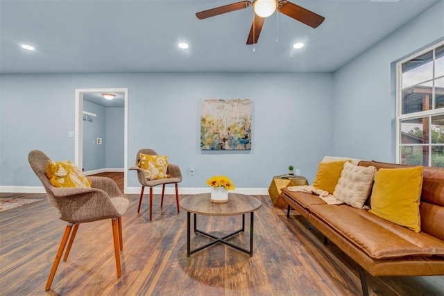 living area featuring recessed lighting, dark wood-style flooring, and baseboards