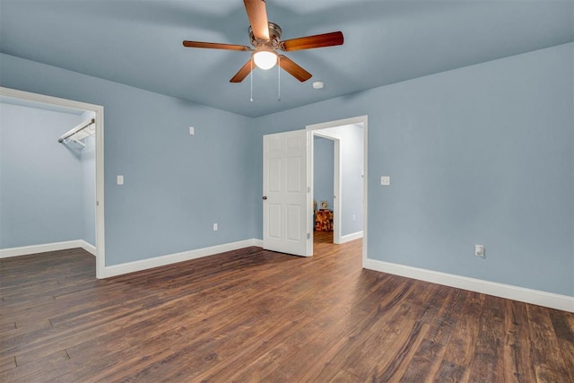 unfurnished room with ceiling fan, baseboards, and wood finished floors