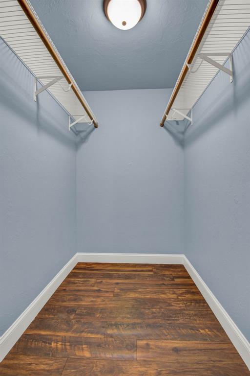 spacious closet with wood finished floors