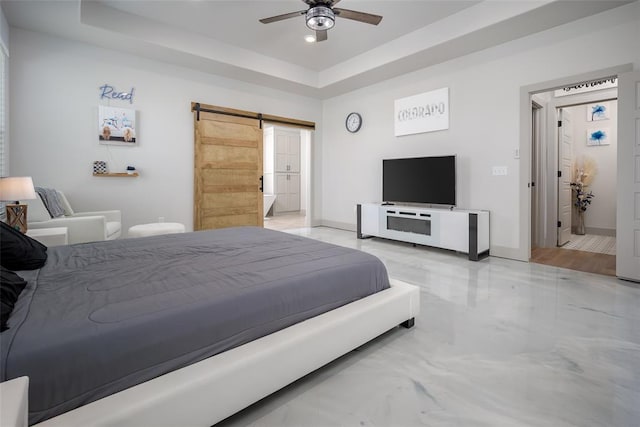 bedroom with a barn door, baseboards, ceiling fan, marble finish floor, and a tray ceiling