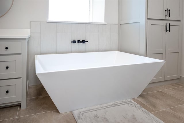 full bathroom with tile patterned flooring and a freestanding tub