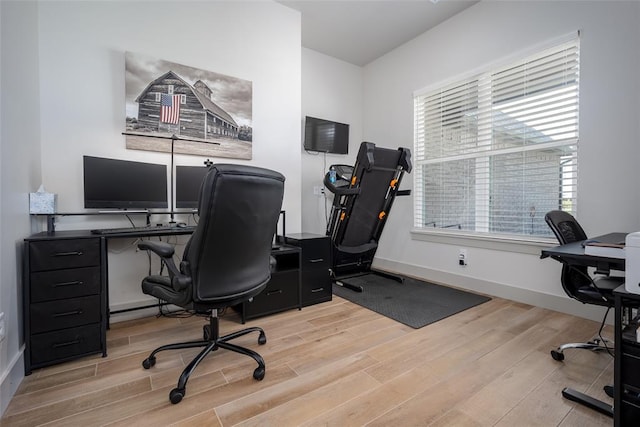 home office featuring baseboards and wood finished floors