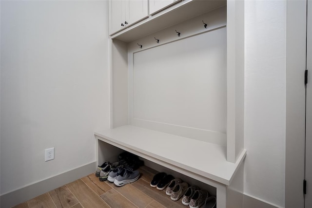 mudroom featuring baseboards and wood finished floors