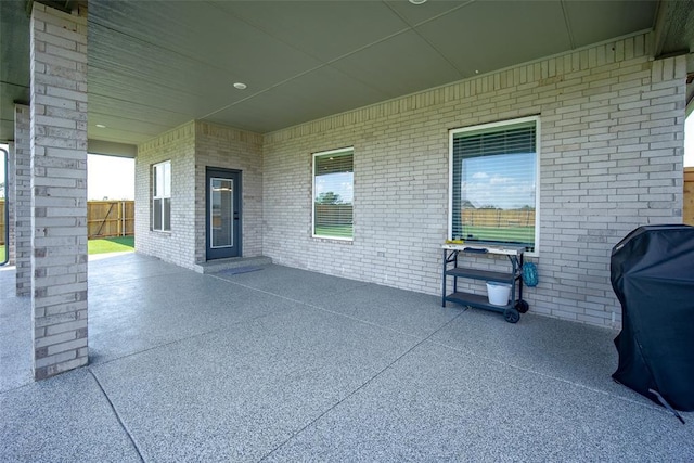 view of patio / terrace with fence and a grill