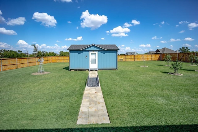 view of yard with a fenced backyard, an outdoor structure, and a storage shed