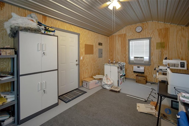 interior space featuring lofted ceiling, wood walls, and carpet floors