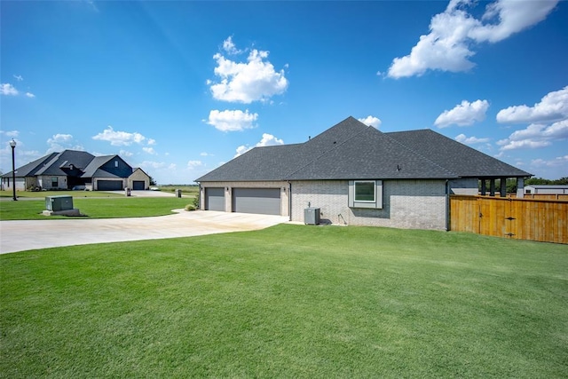 exterior space with brick siding, fence, driveway, a lawn, and roof with shingles