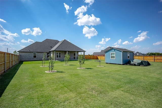 view of yard with an outbuilding and a fenced backyard