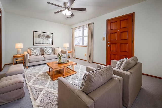 living area with ceiling fan, carpet floors, visible vents, and baseboards