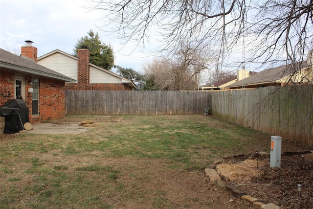 view of yard featuring a patio and a fenced backyard