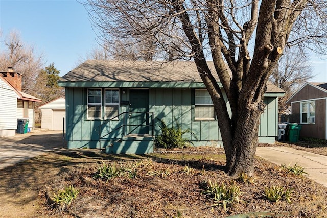 view of front of home featuring board and batten siding and an outdoor structure